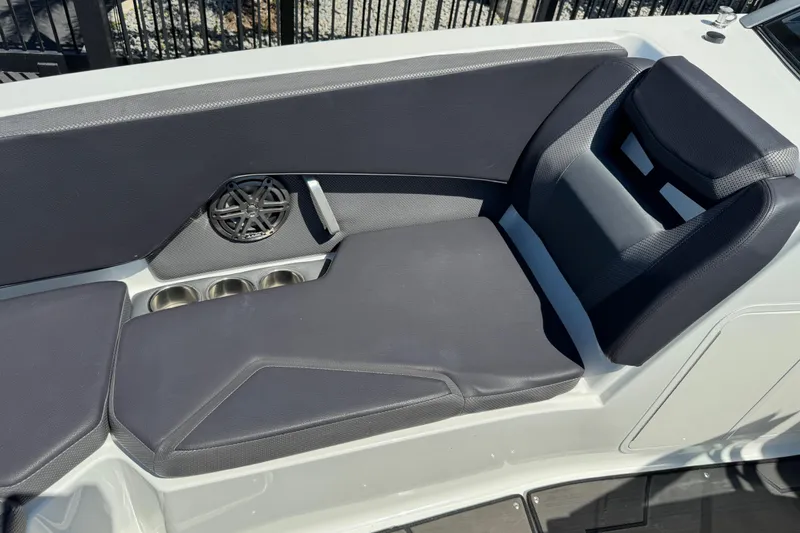 Slide: The Image of 2022 Scarab 285 ID boat interior with cushioned seating and speaker. - 50