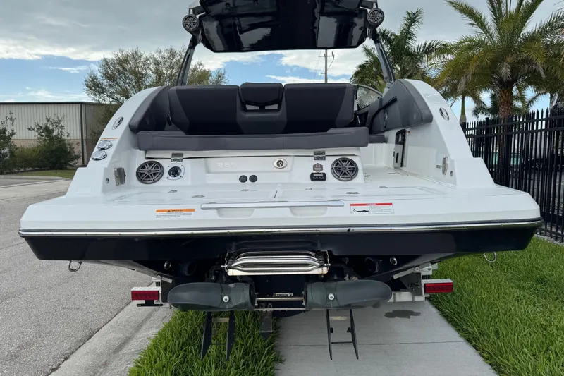 Slide: The Image of 2022 Scarab 285 ID boat rear view with speakers and seating, outdoors. - 6