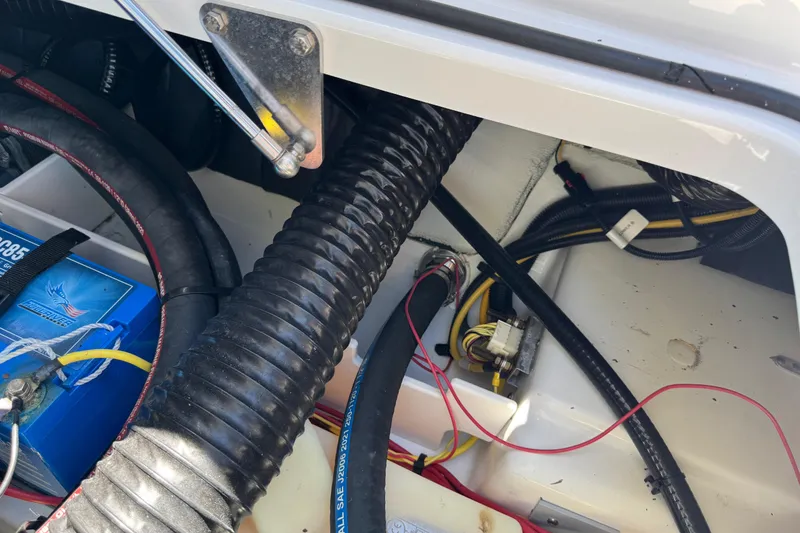 Slide: The Image of Engine compartment of a 2022 Scarab 285 ID boat, showing wiring and battery connections. - 64