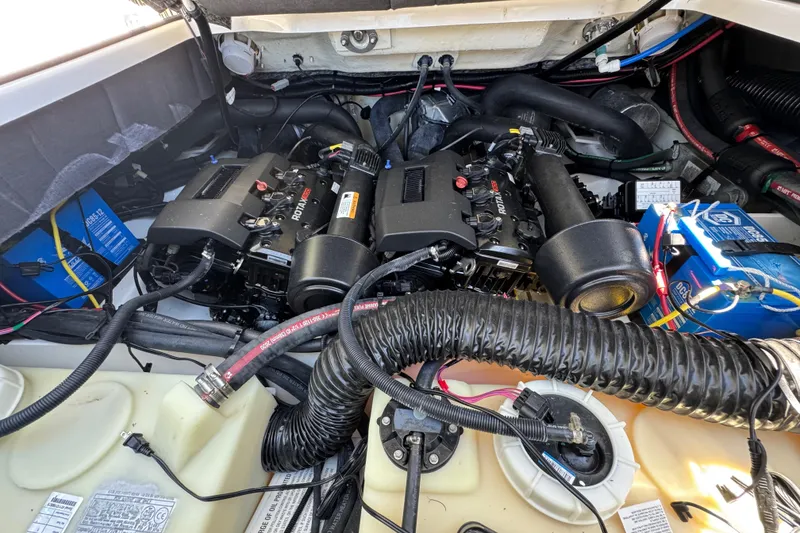 Slide: The Image of Engine compartment of a 2022 Scarab 285 ID boat, featuring Rotax engines. - 67