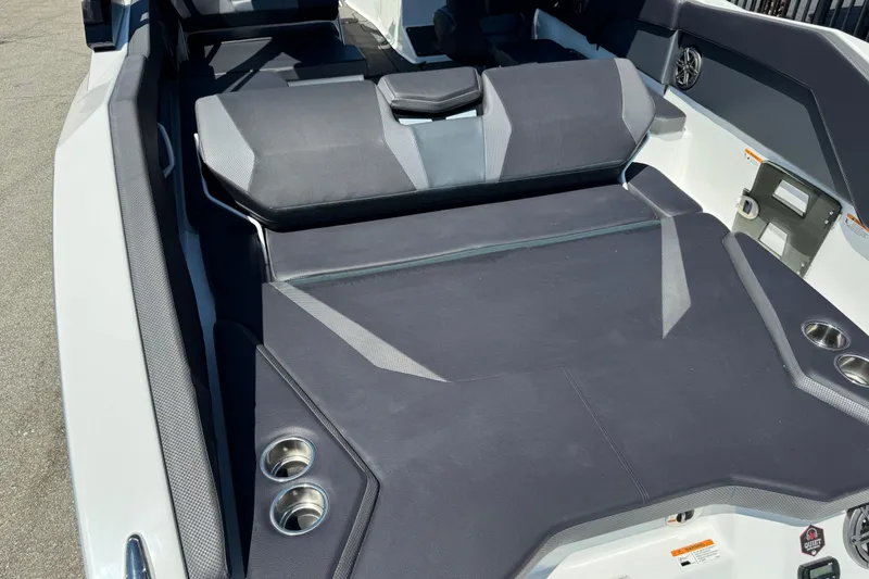 Slide: The Image of 2022 Scarab 285 ID boat interior with cushioned seating and cup holders. - 71