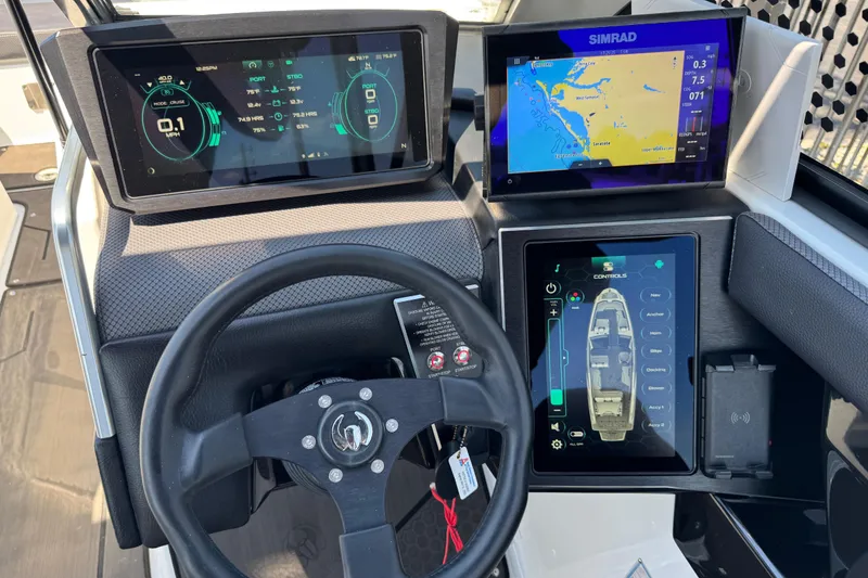 Slide: The Image of Dashboard of a 2022 Scarab 285 ID boat with digital displays and navigation controls. - 77