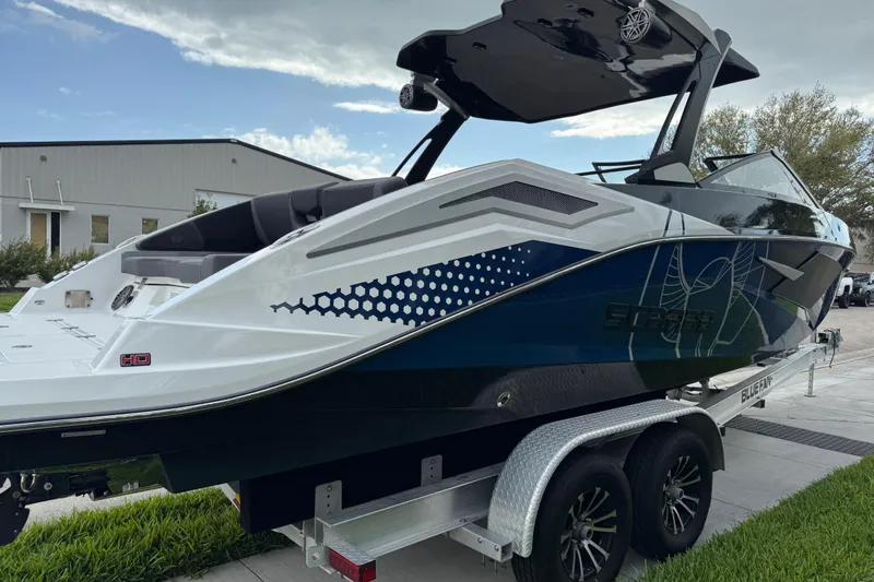 Slide: The Image of 2022 Scarab 285 ID boat on trailer, sleek design, modern graphics, outdoor setting. - 8