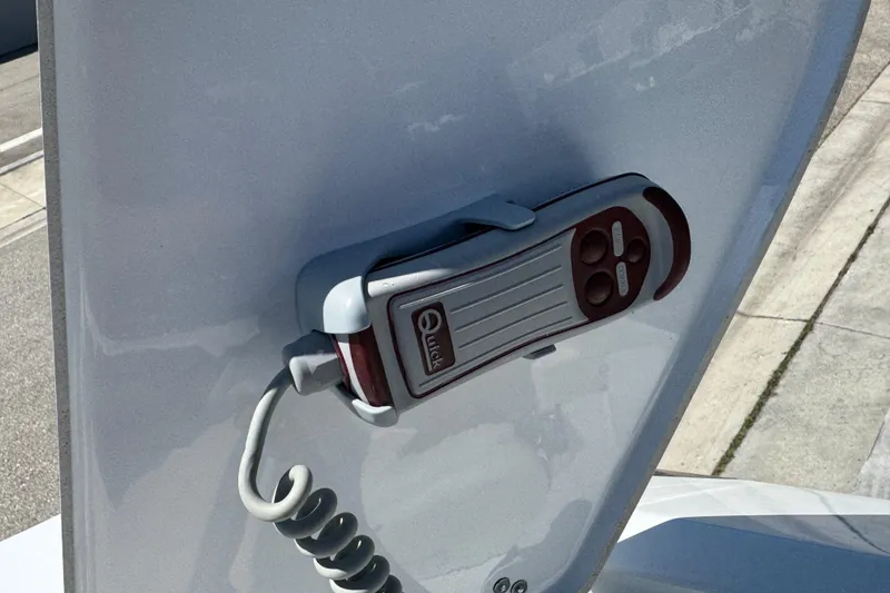 Slide: The Image of Remote control mounted on a 2022 Scarab 285 ID boat surface. - 81