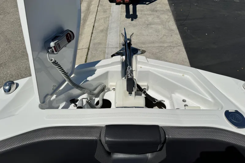 Slide: The Image of 2022 Scarab 285 ID boat anchor compartment with open hatch and control panel. - 82
