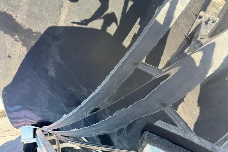 Slide: The Image of Close-up of 2022 Scarab 285 ID boat hull with visible reflections and shadows. - 90