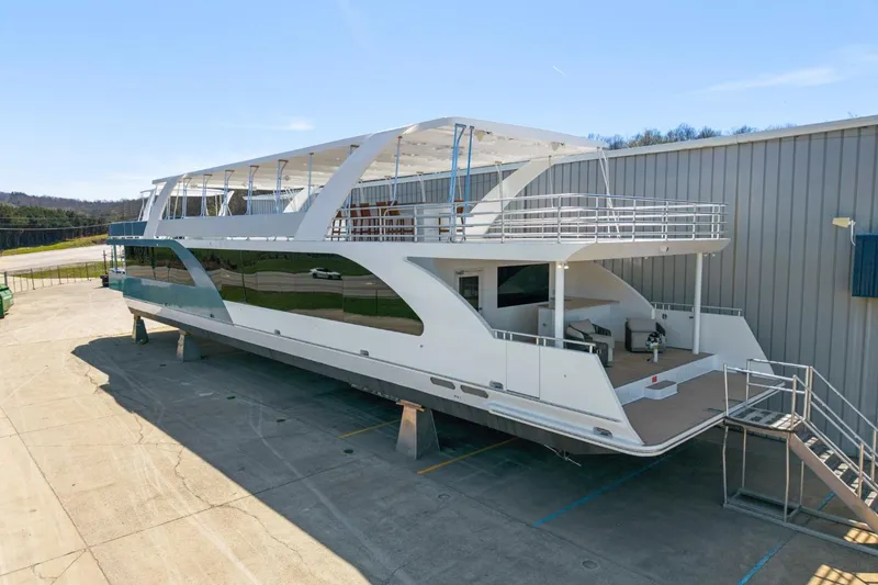 The Image of Modern 2019 Sumerset 20x100 houseboat on dry dock, showcasing sleek design and spacious decks. - 0