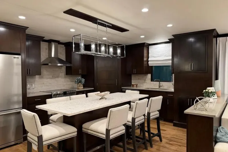 Slide: The Image of Luxurious kitchen interior on 2019 Sumerset houseboat, featuring dark wood cabinets and modern lighting. - 18