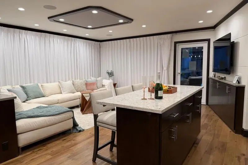 Slide: The Image of Luxurious 2019 Sumerset houseboat interior with modern kitchen, cozy seating, and elegant decor. - 20