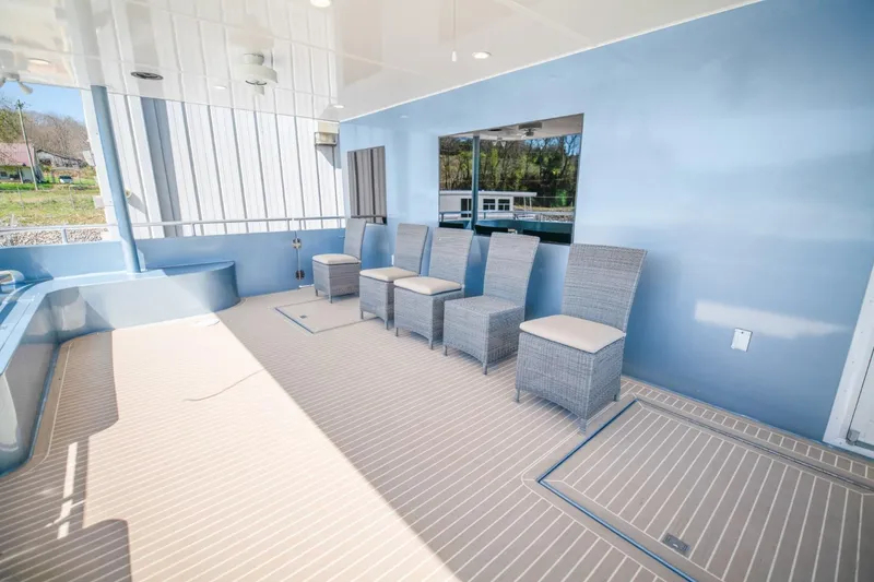 Slide: The Image of Spacious deck of 2019 Sumerset 20x100 houseboat with wicker chairs and blue accents. - 27