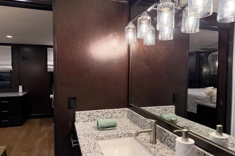 Slide: The Image of Luxurious bathroom interior of 2019 Sumerset Houseboat with granite countertop and elegant lighting. - 4