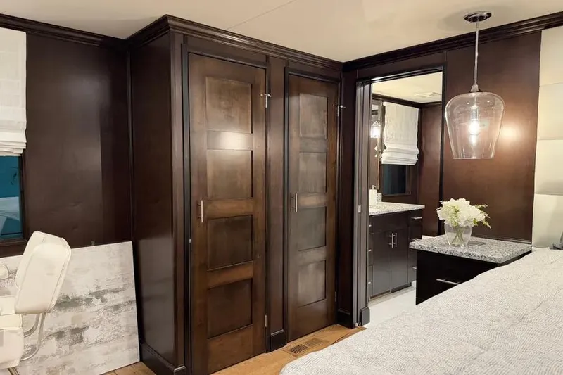 Slide: The Image of Luxurious 2019 Sumerset houseboat interior with dark wood cabinetry and modern lighting. - 5