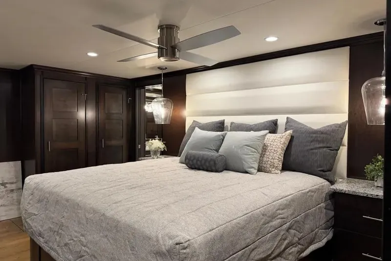 Slide: The Image of Luxurious bedroom interior of 2019 Sumerset Houseboat, featuring elegant bedding and modern lighting. - 7
