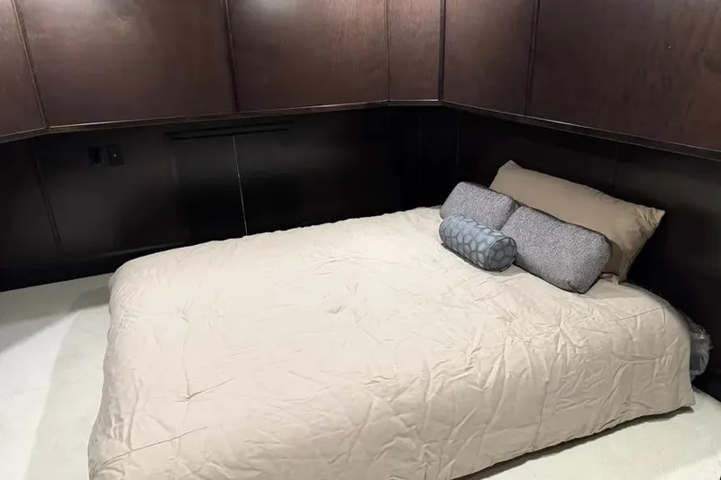 Slide: The Image of Cozy bedroom in 2019 Sumerset Houseboat with dark wood paneling and beige bedding. - 9