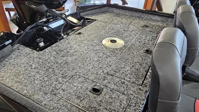 Slide: The Image of Interior of 2026 Tracker Pro Team 175 TF boat, gray carpet flooring. - 7