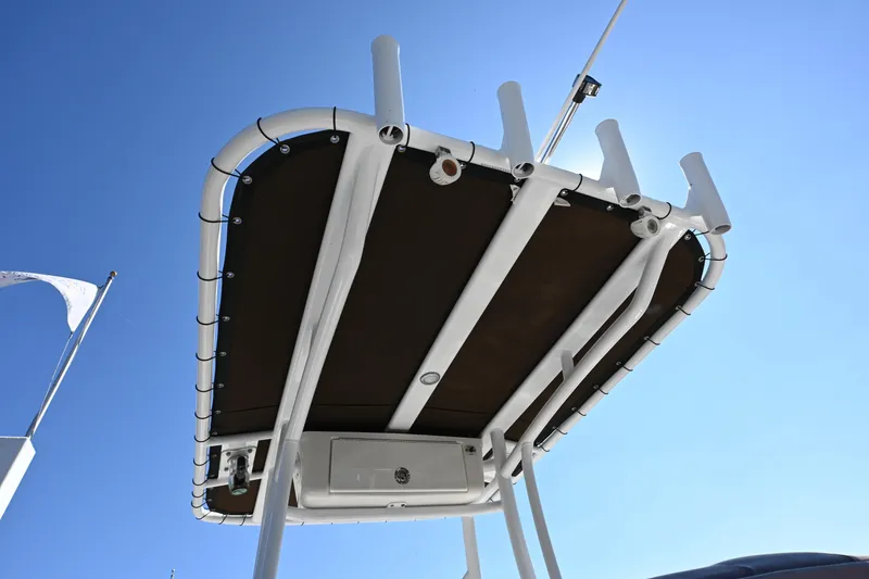 Slide: The Image of Tidewater 210 LXF 2017 boat canopy with rod holders against clear blue sky. - 12