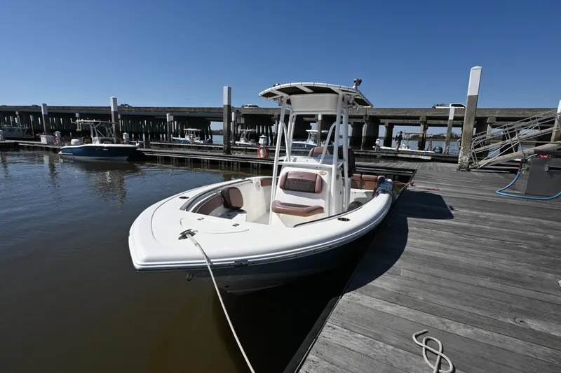 Slide: The Image of 2017 Tidewater 210 LXF boat docked at a marina under clear blue skies. - 15