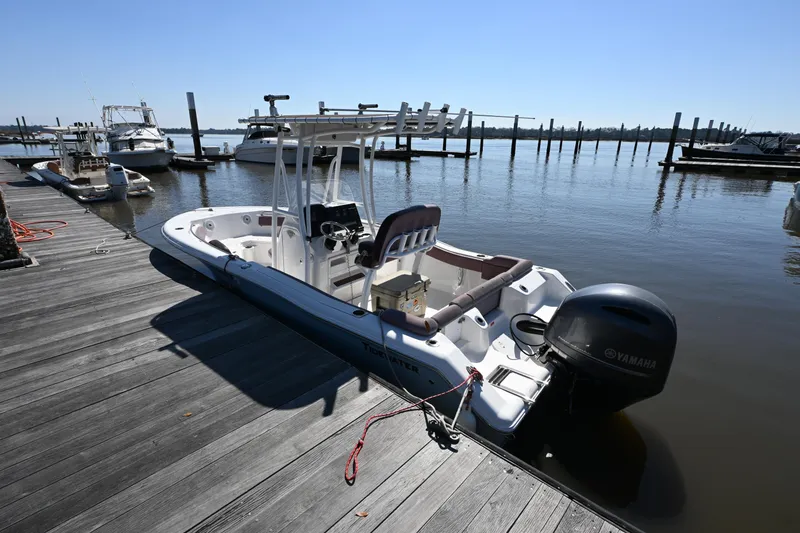 Slide: The Image of 2017 Tidewater 210 LXF boat docked at marina with Yamaha outboard motor. - 16