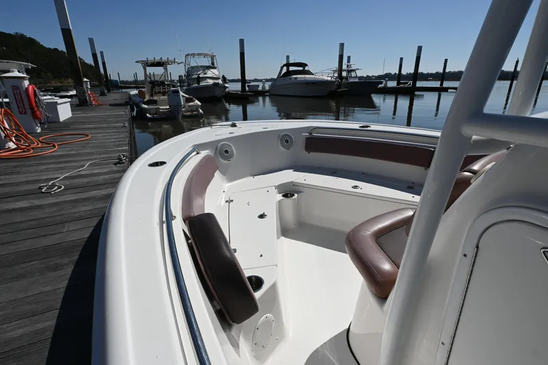 Slide: The Image of 2017 Tidewater 210 LXF boat docked at marina, featuring sleek seating and calm waters. - 5
