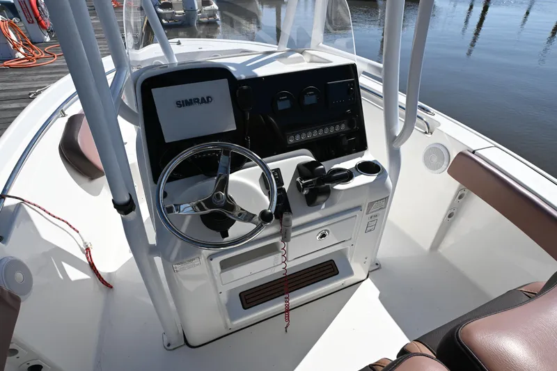 Slide: The Image of 2017 Tidewater 210 LXF boat console with steering wheel and Simrad display. - 8