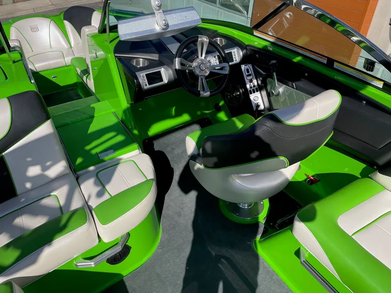 Slide: The Image of Interior of a 2013 MasterCraft XStar boat with green and white design. - 6