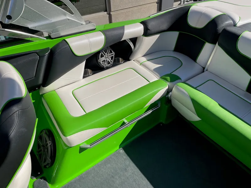 Slide: The Image of Interior of a 2013 MasterCraft XStar with green and white upholstery. - 7