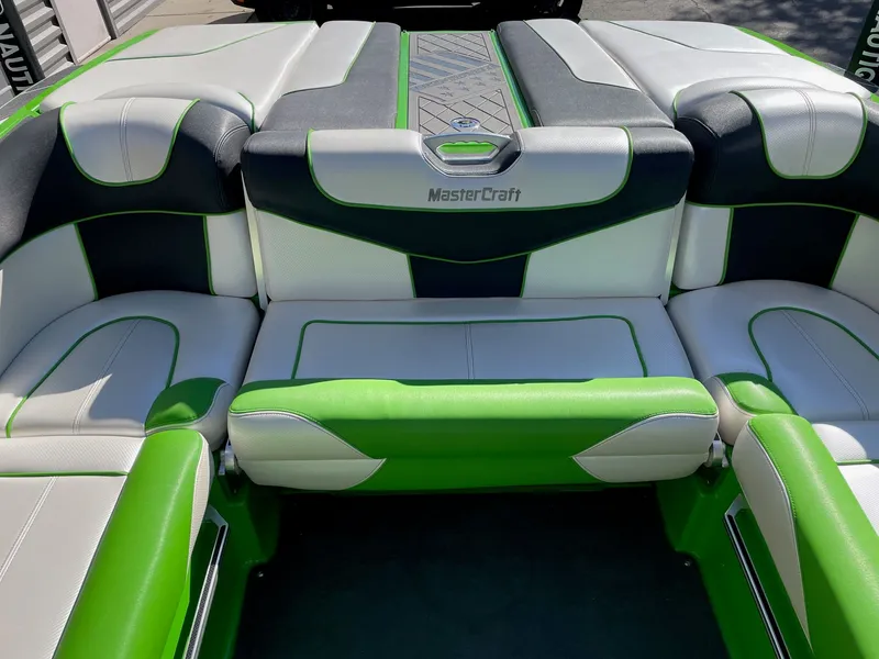 Slide: The Image of 2013 MasterCraft XStar boat with green and white seating. - 8