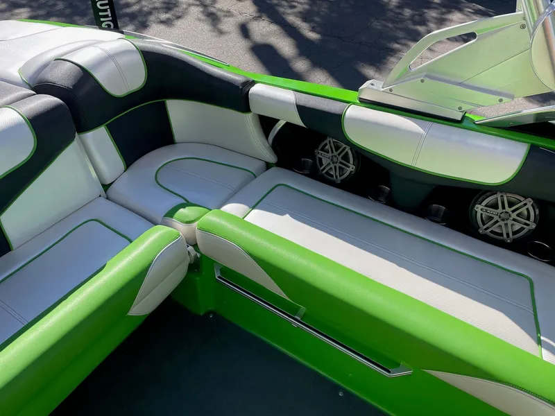 Slide: The Image of Green and white interior of a 2013 MasterCraft XStar boat. - 9
