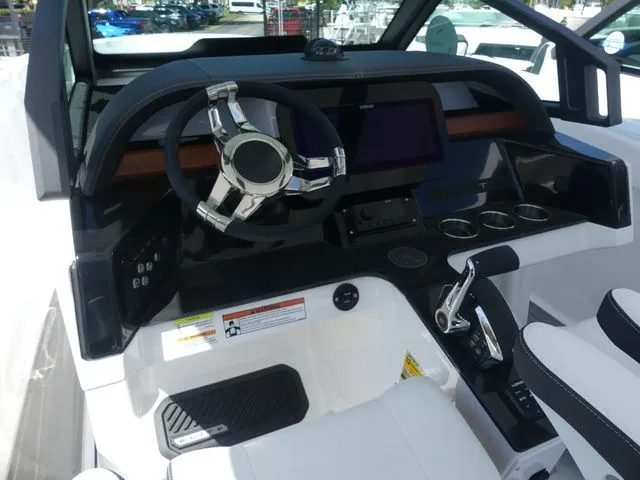 Slide: The Image of 2026 Monterey Elite 25 OB cockpit with modern steering and instruments. - 12