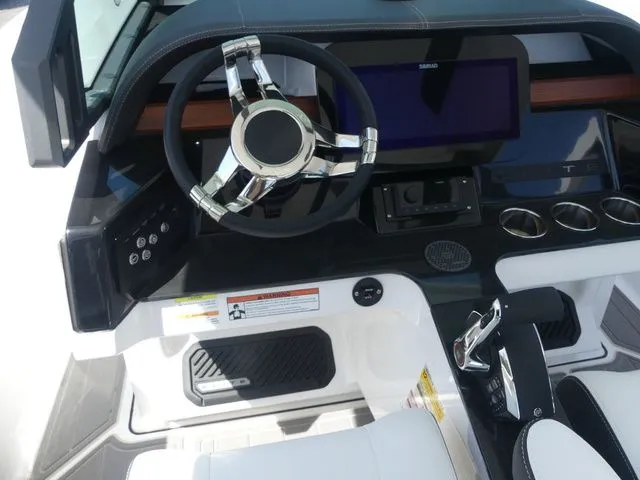 Slide: The Image of 2026 Monterey Elite 25 OB cockpit with modern steering wheel and controls. - 16