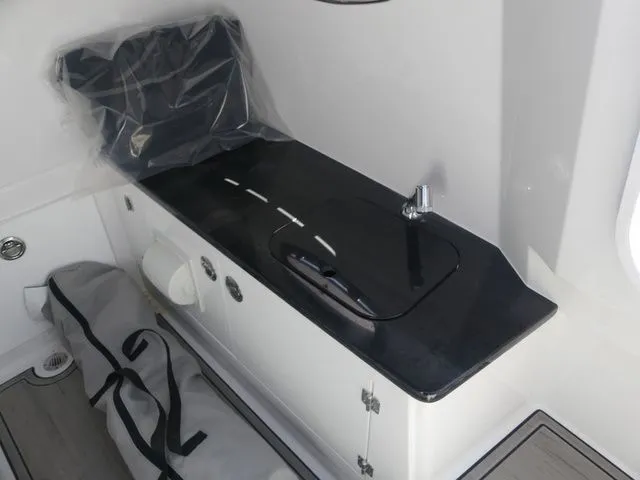 Slide: The Image of Interior of 2026 Monterey Elite 25 OB with sink and storage. - 22