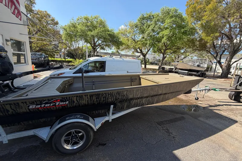 Slide: The Image of 2026 Gator Tail 1754 Extreme boat on trailer, parked outdoors under trees. - 4