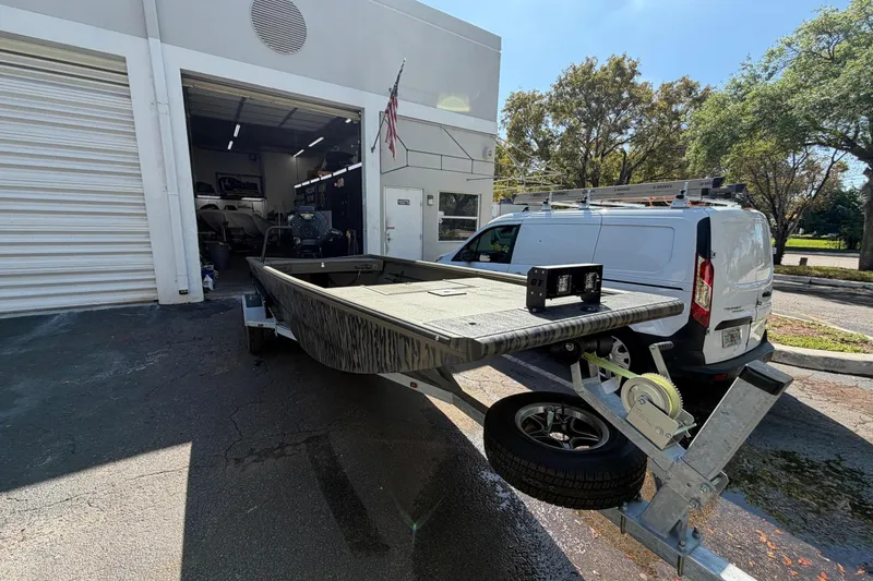 Slide: The Image of 2026 Gator Tail 1754 Extreme boat on trailer outside a garage. - 5