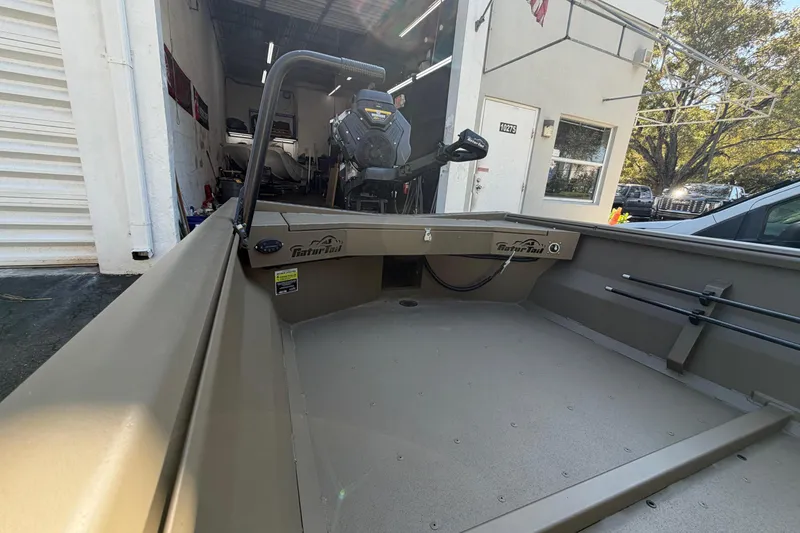 Slide: The Image of 2026 Gator Tail 1754 Extreme boat in a garage, showcasing interior and motor. - 6