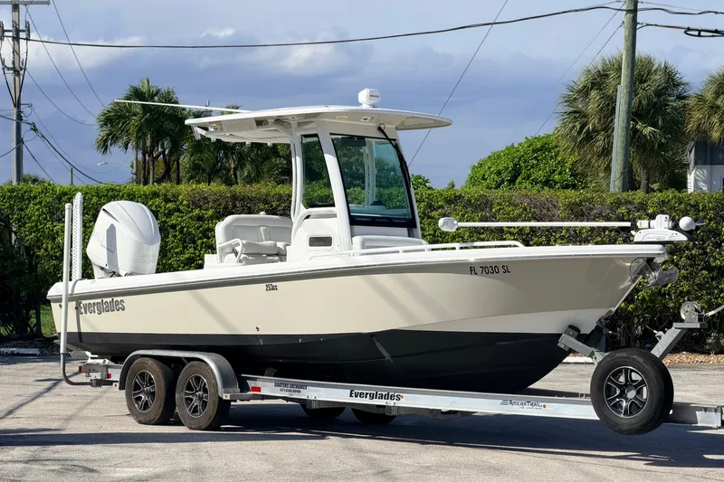 The Image of 2019 Everglades 253 Center Console boat on trailer, parked outdoors. - 0