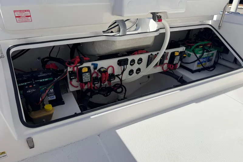 Slide: The Image of 2019 Everglades 253 Center Console boat battery compartment with wiring and components. - 10