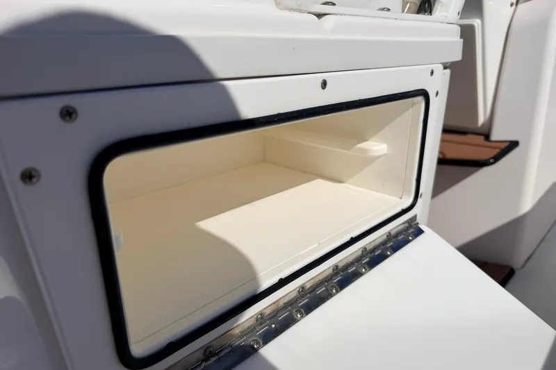 Slide: The Image of Open storage compartment on 2019 Everglades 253 Center Console boat. - 14