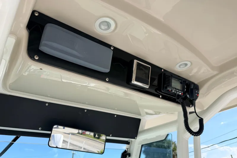 Slide: The Image of 2019 Everglades 253 Center Console boat dashboard with radio and controls. - 16