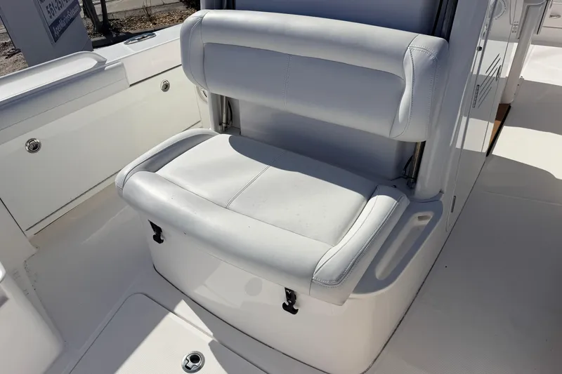 Slide: The Image of 2019 Everglades 253 Center Console boat seat, white upholstery, sleek design. - 19