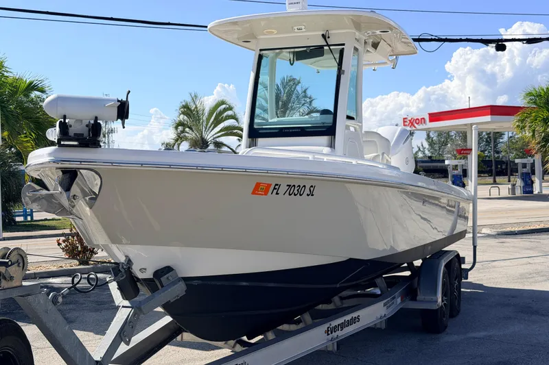 Slide: The Image of 2019 Everglades 253 Center Console boat on trailer near gas station. - 2