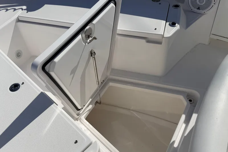 Slide: The Image of Open storage compartment on 2019 Everglades 253 Center Console boat. - 23