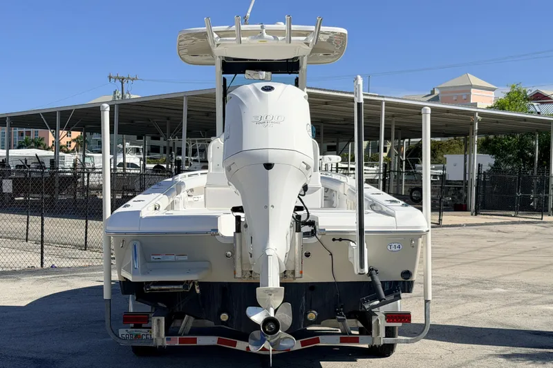 Slide: The Image of 2019 Everglades 253 Center Console boat with powerful outboard motor, parked in marina. - 5