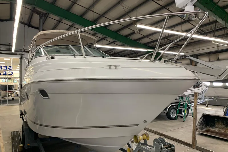 Slide: The Image of 2003 Four Winns 248 Vista boat in indoor storage facility. - 1