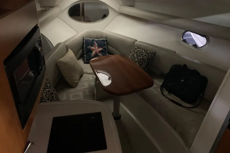 Slide: The Image of Cozy interior of 2003 Four Winns 248 Vista boat with seating and table. - 11