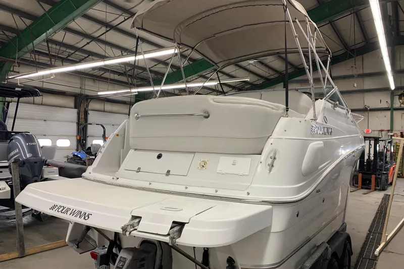 Slide: The Image of 2003 Four Winns 248 Vista boat in a warehouse, rear view with canopy. - 5