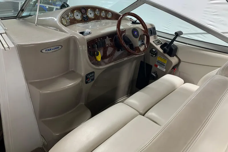 Slide: The Image of 2003 Four Winns 248 Vista boat interior with steering wheel and dashboard controls. - 7