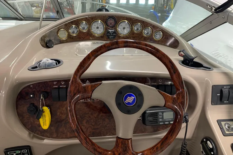 Slide: The Image of 2003 Four Winns 248 Vista boat dashboard with woodgrain steering wheel and instrument panel. - 8