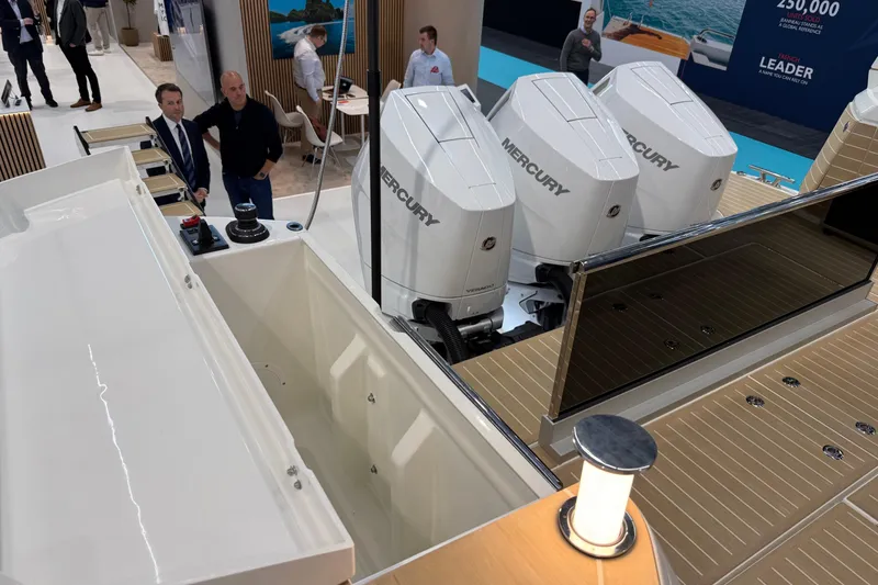 Slide: The Image of 2026 Saxdor 460 GTC boat with Mercury engines displayed at a boat show. - 10