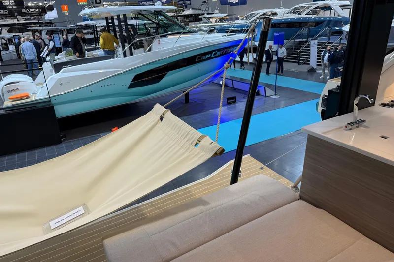 Slide: The Image of 2026 Saxdor 460 GTC yacht interior with hammock, showcased at a boat exhibition. - 11