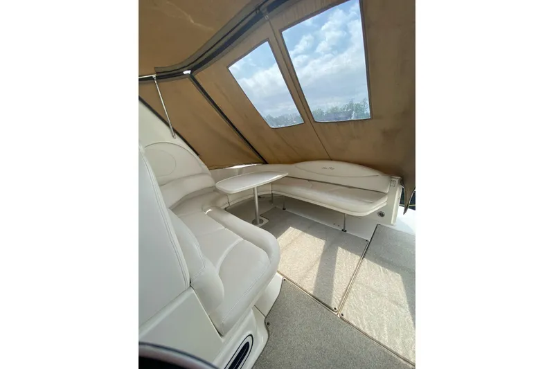 Slide: The Image of Interior of 2001 Sea Ray 380 Sundancer with beige seating and table under canopy. - 10